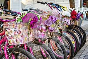 Parked bicycles with flowers in baskets