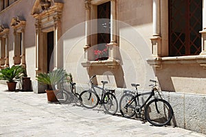 Parked bicycles near a building in Alcudia