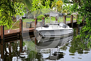 parked boat at dock on canal in Florida, USA