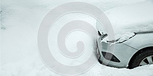 a parked car near a snowdrift covered with a pile of snow.