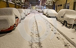 Parked cars covered in snow