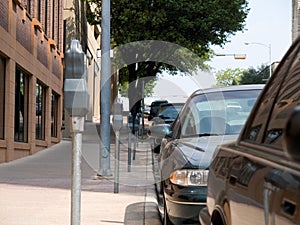 Parked cars and parking meters photo