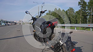 Parked electric motorcycle. Smoothly rising camera.