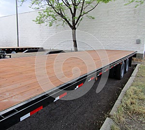 Parked flat bed semi trailer platform