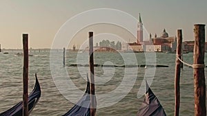 Parked gondolas on Piazza San Marco and The Doge's Palace embankment with the bell tower of the Saint Giorgio Maggiore