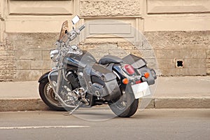 Parked motorcycle by the sidewalk