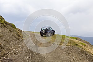 Parked off road car in a mountain landscape