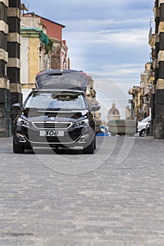 Parked Peugeot 308 car on Battaglia di Palestro plaza