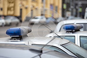 parked police cars with the blue flashing light turned off