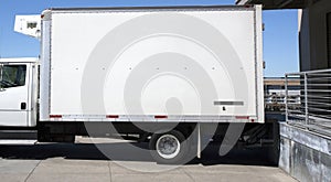 Parked refrigerated truck at loading dock