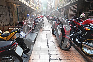 Parked scooters and motorcycles on the Bangkok city street