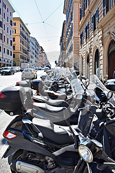 Parked scooters and motorcycles on street