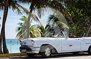 Parked white classic car near the beach in Cuba Havana