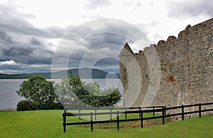 Old Irish castle on lake with mountain background