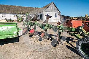 Parking agricultural machinery and harvest. rows of plows, cultivators, bodies