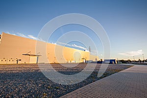 Parking area outside big warehouse. Urban, industrial