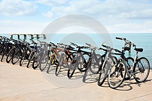 Parking with bicycles on embankment near sea