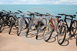 Parking with bicycles on embankment near sea