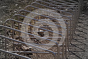 Parking for bicycles near park. stand rhythms. Grey backrround. photo