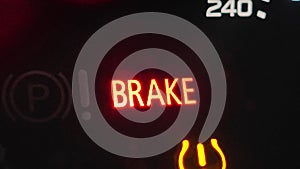 Parking brake warning light, illuminated on the dashboard of a modern car