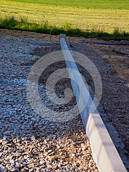 Parking building. Road curbs set at the end of the future parking lot.