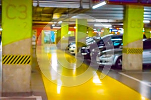 Parking car blurred. Empty road asphalt background in soft focus. Car lot parking space in underground city garage. Interior