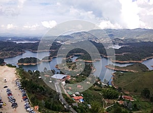 Parking with cars and tourists arriving at the Guatape lakes and the PeÃ±ol rock