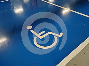 Parking for the disabled. The parking lot has a blue background and has a special logo.