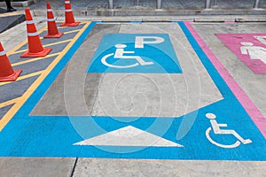 Parking for disabled or wheelchair. A sign indicates reserved parking for disabled people in a car park.  International handicappe photo