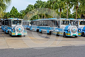 Parking with fun vehicles in the form of a blue steam locomotives for carries tourists and visitors on the territory of Buddhist