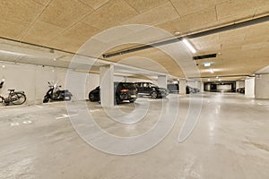 a parking garage with cars and motorcycles in it