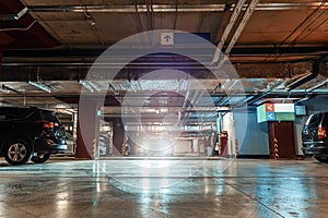 Parking Garage, Illuminated Underground Car Park Lots under modern Mall with Vehicles