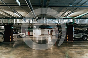 Parking Garage, Illuminated Underground Car Park Lots under modern Mall with Vehicles