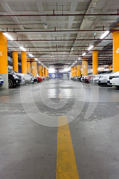 Parking garage, underground interior with a few parked cars