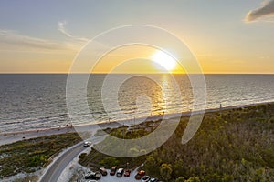 Parking lot at Blind Pass beach on Manasota Key in Englewood. Tourists cars in front of ocean beach with soft white sand