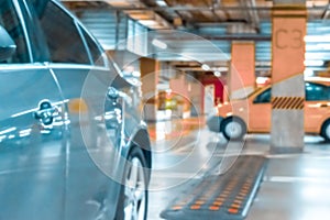 Parking lot blurred. Car lot parking space in underground city garage. Empty road asphalt background in soft focus. Ground floor