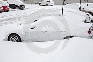 Parking lot with cars covered with snow