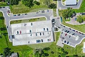 Parking lot with cars and multistorey car parking in residential area. aerial view