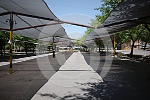 Parking lot for cars under fabric canopy. Municipal parking near Municipality of Mendoza city, Argentina. Parking spaces under