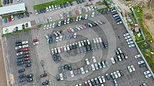 Parking lot at dealer site for sale market, aerial view