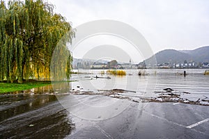 A parking lot is flooded by river water