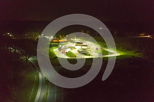 Parking lot at a gas station for trucks seen at night.