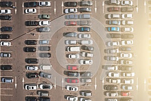 Parking lot with many parked cars at business center or mall, aerial view. City transportation concept