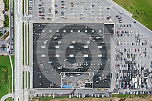 Parking lot with parked cars near big city supermarket. aerial top view