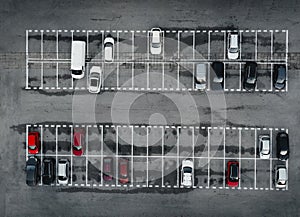 Parking lot and parked colorful cars between the lines from above (top view) - grey concrete background