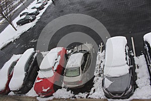 Parking lot in Philadelfia with cars full of snow.