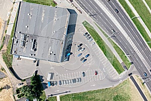 Parking lot with rows of parked cars. shopping mall, aerial view