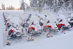 Parking lot for snowmobiles in the snow