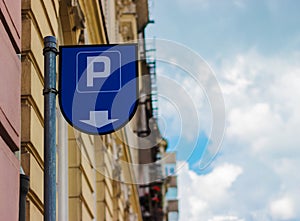 Parking meter sign, on the background of a blue sky in a close-up