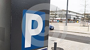 parking meter sign blue white p car parked in city street
